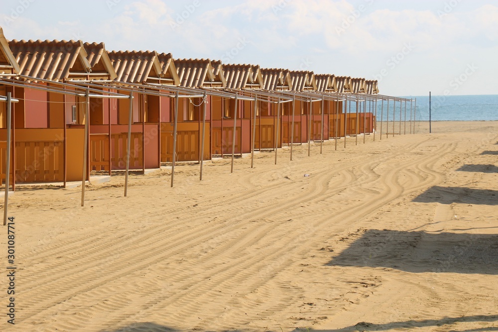 Closed beach huts on the famous Lido beach in Venice, in the low season in October. Lido di Venezia, Italy, Europe.