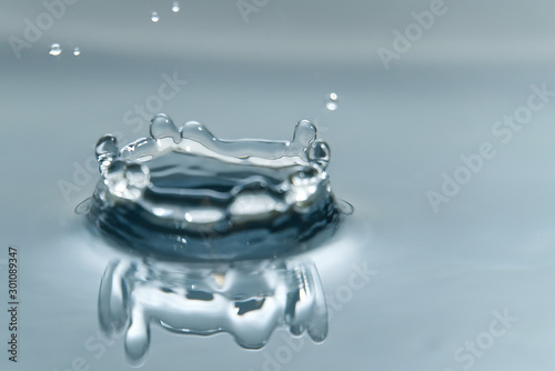 Beautiful splash of water drop on water surface  macro photo