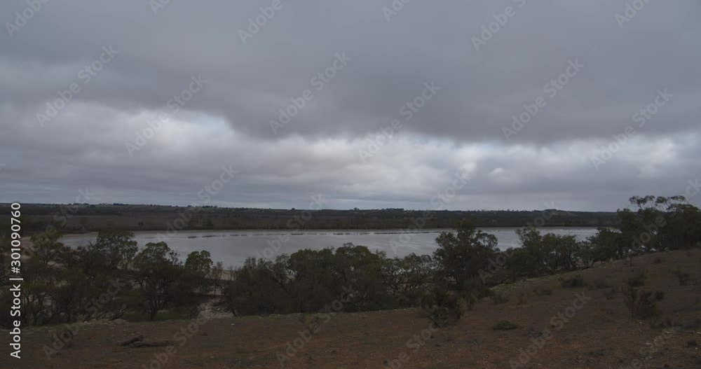 The view of a dried-up riverbank and storm clouds at Loveday in South Australia, Australia The view of a dried-up riverbank and storm clouds at Loveday in South Australia, Australia