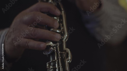 A man playing a clarinet. SLOW MOTION, CLOSE UP. photo