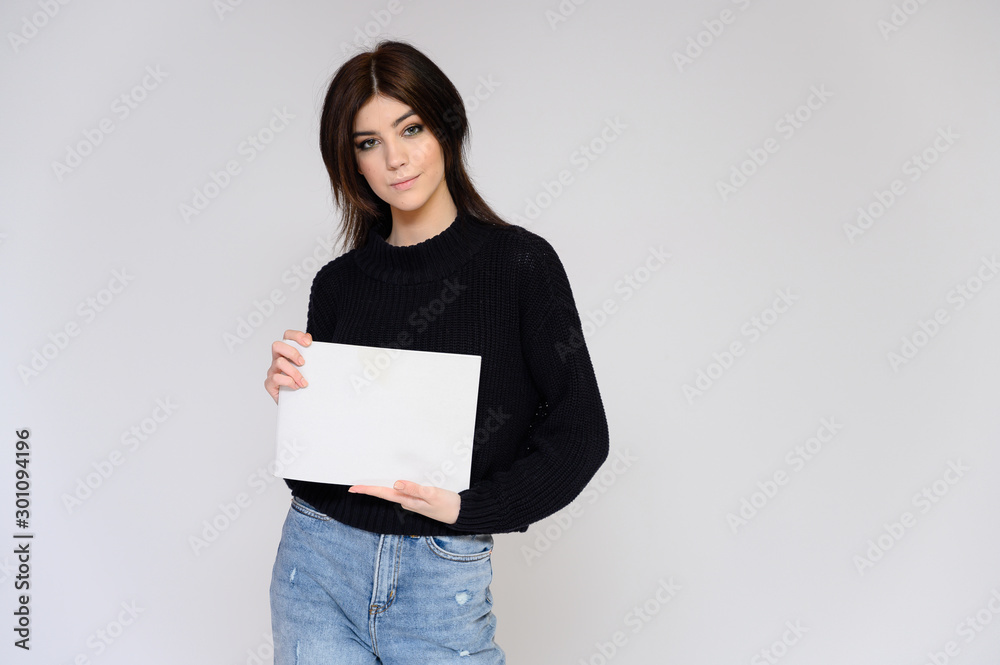 Portrait of a young pretty girl student with long black hair, on a white background. He stands right in front of the camera, showing his hands in different poses with different emotions. Portrait of a young pretty girl student with long black hair, on a white background. He stands right in front of the camera, showing his hands in different poses with different emotions.