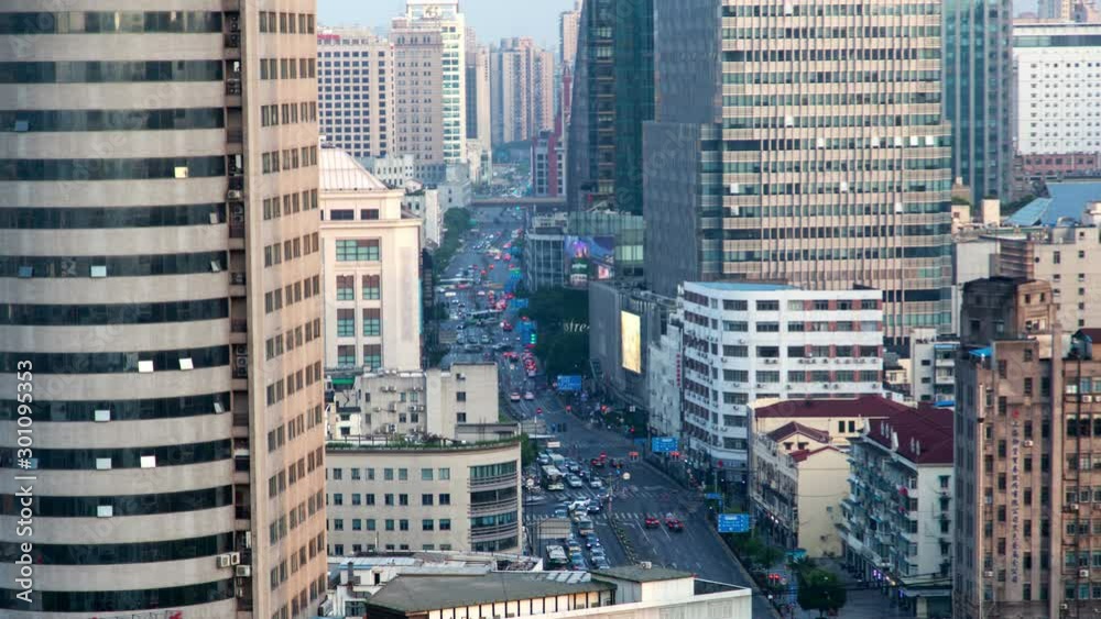 Timelapse heavy traffic on Chinese street highway surrounded by modern Shanghai buildings with flashing coloured advertisements on large displays on July 12 in Shanghai Timelapse heavy traffic on Chinese street highway surrounded by modern Shanghai buildings with flashing coloured advertisements on large displays on July 12 in Shanghai