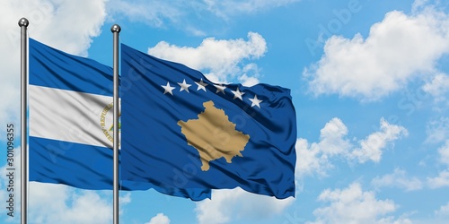 Nicaragua and Kosovo flag waving in the wind against white cloudy blue sky together. Diplomacy concept, international relations.
