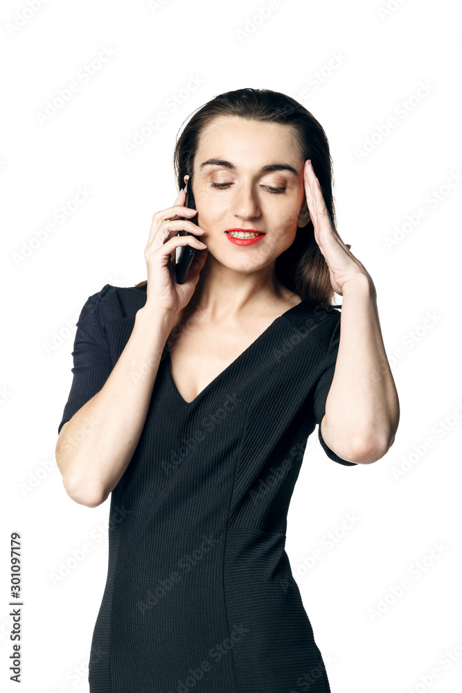 Business woman (fatal woman) in a black dress with red lipstick talking on the phone, isolated on a white background. Business woman (fatal woman) in a black dress with red lipstick talking on the phone, isolated on a white background.