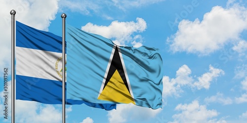 Nicaragua and Saint Lucia flag waving in the wind against white cloudy blue sky together. Diplomacy concept, international relations.