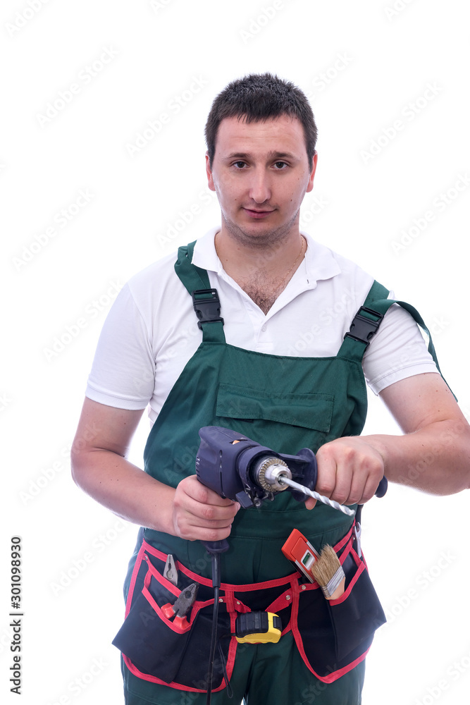 Man in coverall holding drill machine isolated on white Man in coverall holding drill machine isolated on white