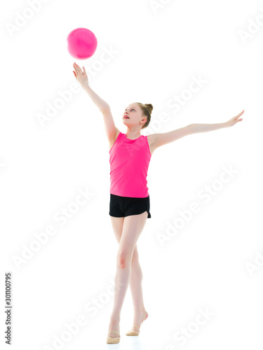 Girl gymnast performs exercises with the ball. © lotosfoto