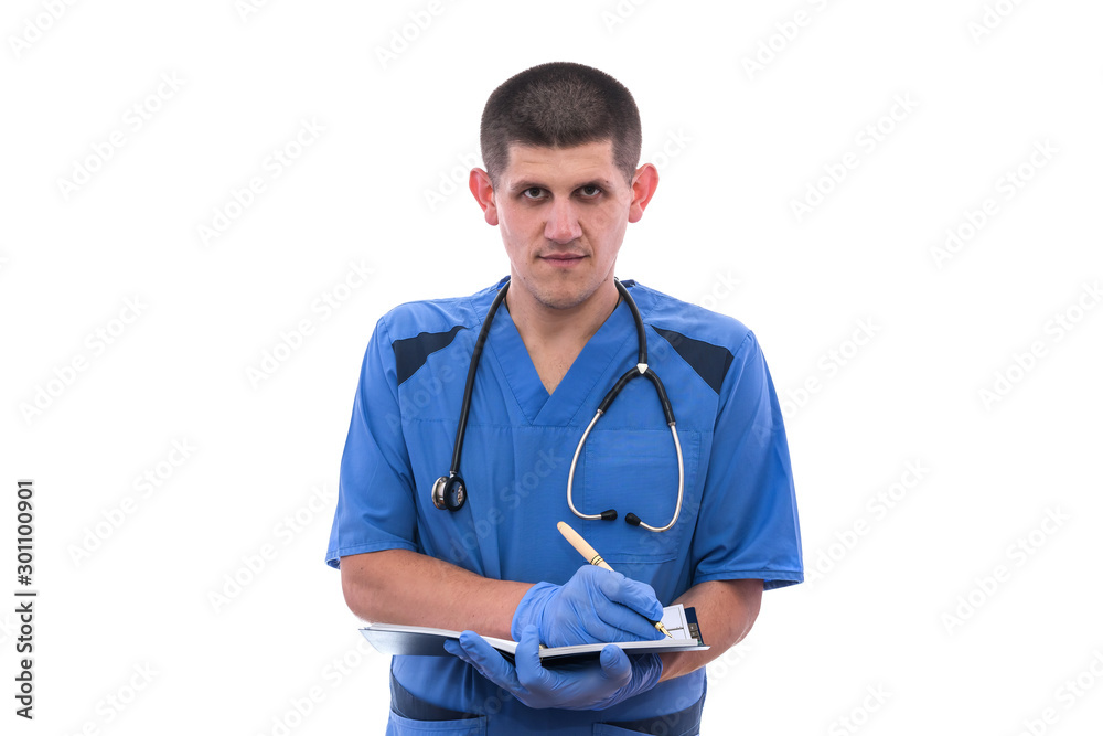 Young male doctor in uniform with stethoscope writing document isolated on white background. Young male doctor in uniform with stethoscope writing document isolated on white background.