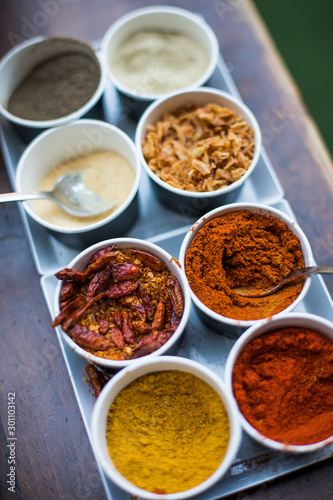 Fototapeta Naklejka Na Ścianę i Meble -  Various colored spices in recipients