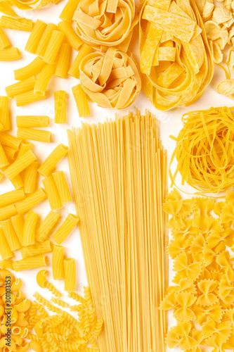 Italian pasta variety, flat lay banner, top shot on a white background. Spaghetti, macaroni, farfalle, fusilli, pappardelle etc