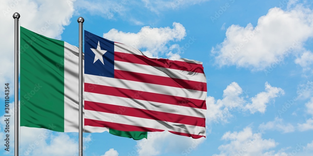 Nigeria and Liberia flag waving in the wind against white cloudy blue sky together. Diplomacy concept, international relations.