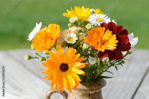 autumnal colorful bunch of flowers with asters  calendula and dahlias