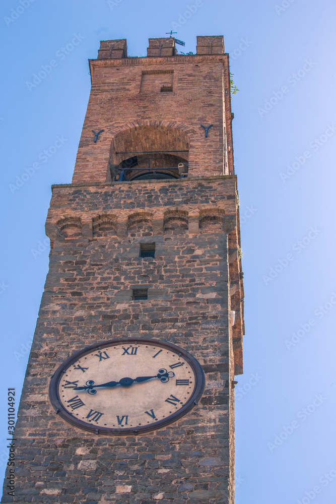 Old stone Bell tower with clock in Pienza Italy. 