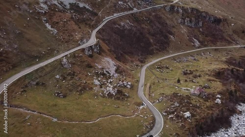 Aerial top down showing road with cars between mountains,switzerland photo