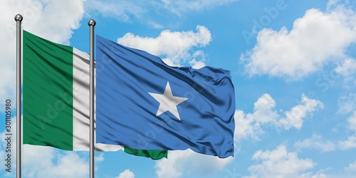 Nigeria and Somalia flag waving in the wind against white cloudy blue sky together. Diplomacy concept, international relations.