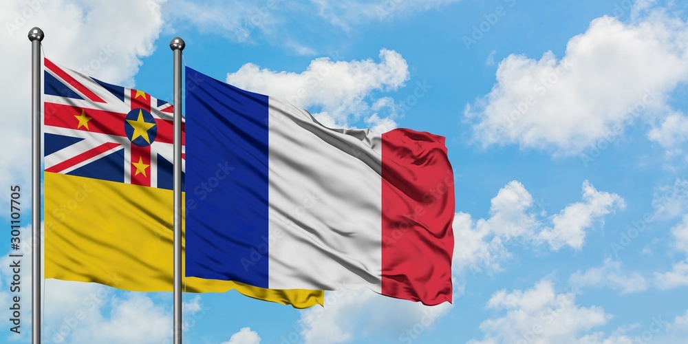 Niue and France flag waving in the wind against white cloudy blue sky together. Diplomacy concept, international relations.