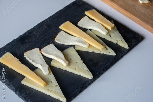 Assortment of different cow and sheep cheeses: Brie, Gouda , Saint Paulin. photo