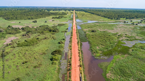 Aerial view of Transpantaneira dirt road crossing straight the typical landscape of North Pantanal Wetlands, Mato Grosso, Brazil photo