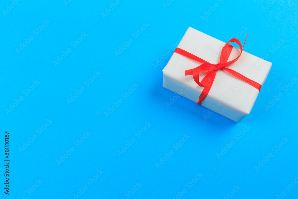Gift box with ribbon and bow on color background and space for text. Top view - Image Gift box with ribbon and bow on color background and space for text. Top view - Image
