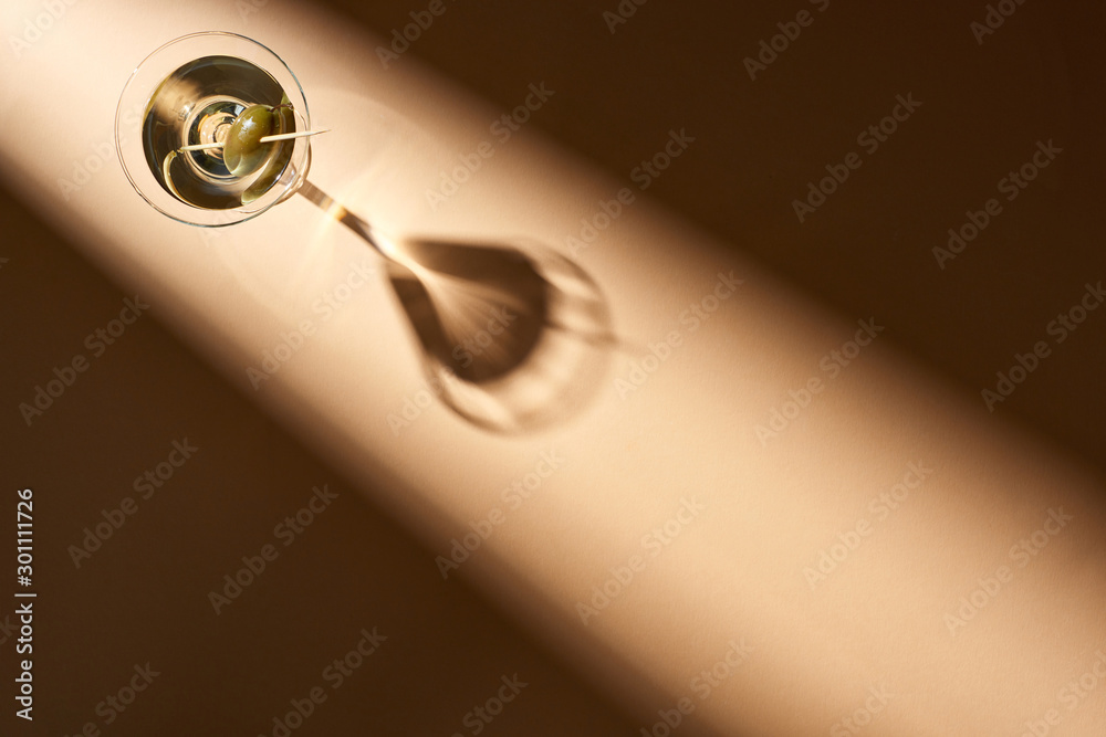 Top view of cocktail with olives on beige background Top view of cocktail with olives on beige background