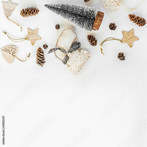 Rustic Handmade Christmas decorations from natural materials  and garland on a white background with copy space. The concept of the new year, christmas and winter holidays.Flat lay, top view. photo