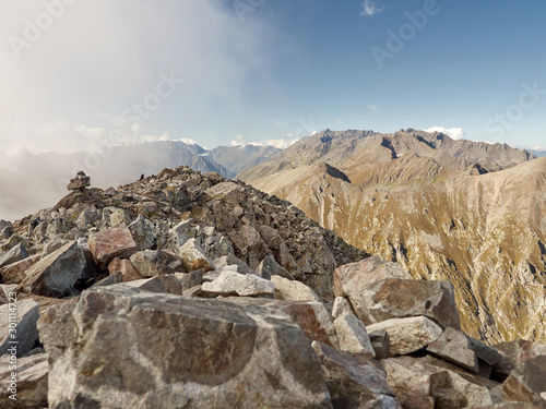 View from rocky mountain peak on stony slopes of Laub ridge  dangerous climbing and trekking route  gorge with steep walls between the arrays Laub and Candish  on mountain top © Maria Shaytor