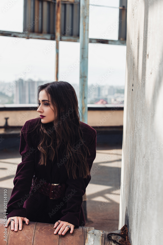 beautiful elegant girl posing in trendy burgundy suit on urban roof beautiful elegant girl posing in trendy burgundy suit on urban roof