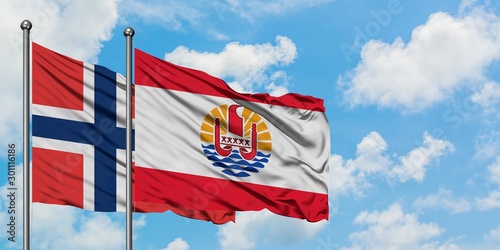 Norway and French Polynesia flag waving in the wind against white cloudy blue sky together. Diplomacy concept, international relations.