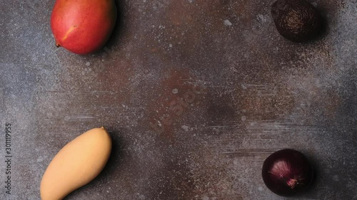 Avocado salad with mango. Top view with  preparation on kitchen table. 4K stopmotion animation