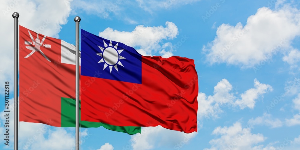 Naklejka premium Oman and Taiwan flag waving in the wind against white cloudy blue sky together. Diplomacy concept, international relations.