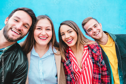 Billede på lærred Happy friends taking selfie with turquoise background - Students having fun with