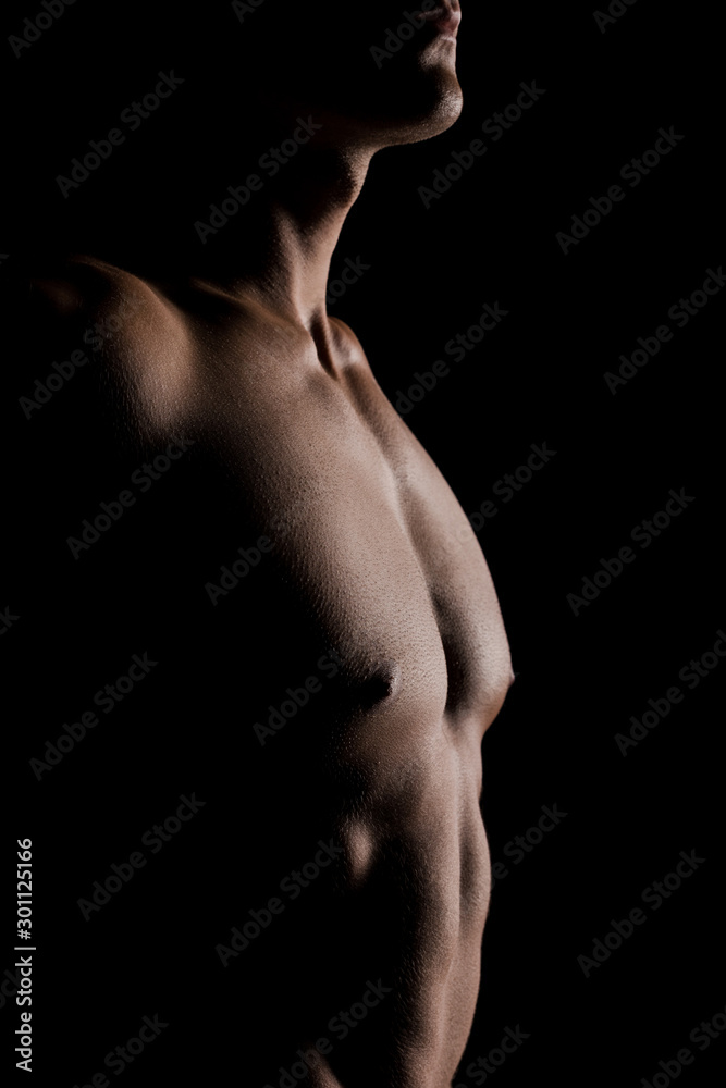 cropped view of shirtless man posing isolated on black