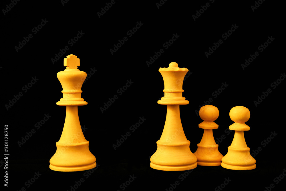 White King and Queen with pawns as divorce and separation concept. Standard chess wooden pieces on black background White King and Queen with pawns as divorce and separation concept. Standard chess wooden pieces on black background