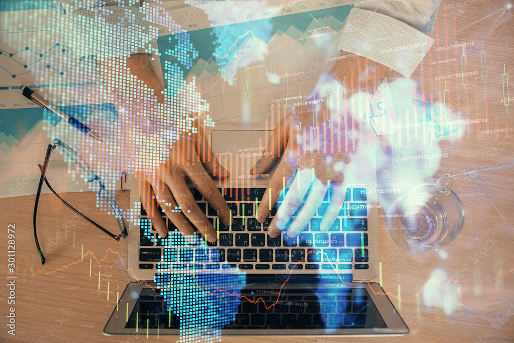Double exposure of market chart with man working on computer on background. Concept of financial analysis.