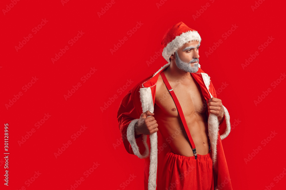 Adult Santa Claus takes off the costume, looking away