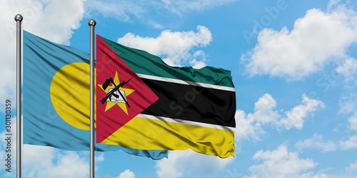 Palau and Mozambique flag waving in the wind against white cloudy blue sky together. Diplomacy concept  international relations.