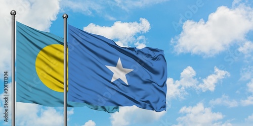Palau and Somalia flag waving in the wind against white cloudy blue sky together. Diplomacy concept, international relations.