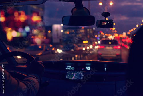 Driving a car in the city at night in traffic jams