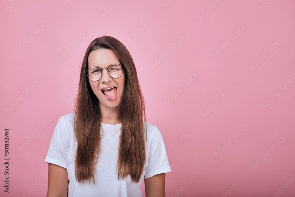 Happy joyful woman with her tongue sticking out to side and covered with one eye Happy joyful woman with her tongue sticking out to side and covered with one eye