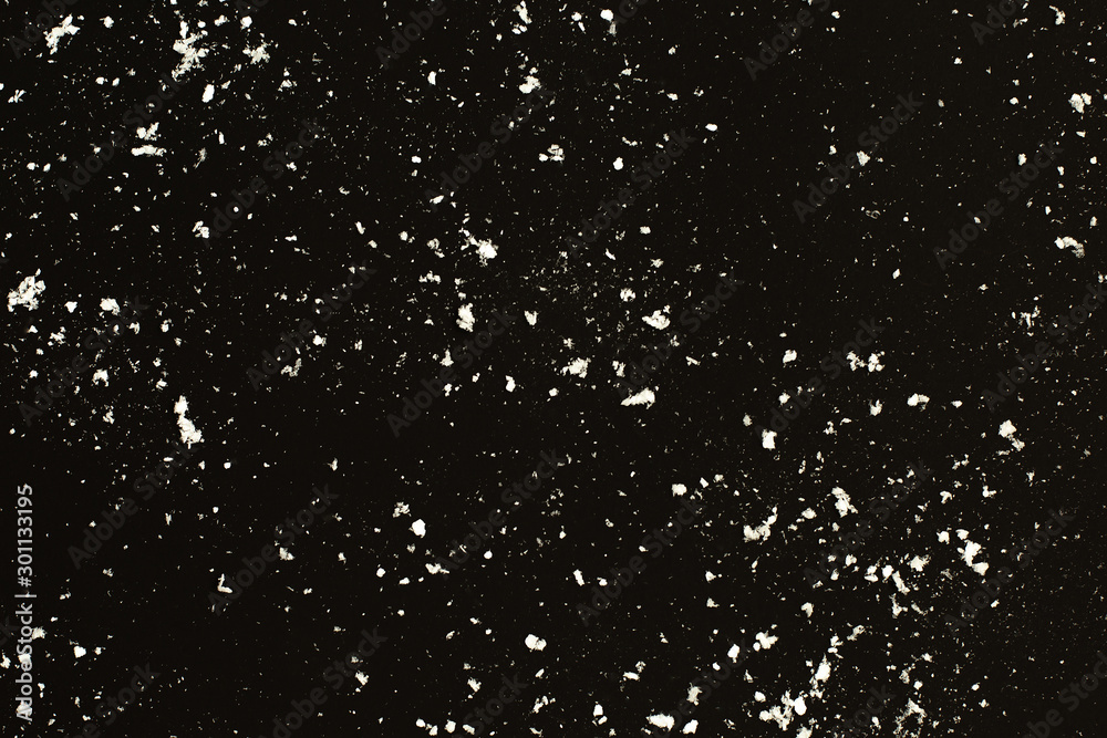 Falling snow on black background. Snowstorm texture.