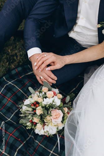 wedding bouquet in the hands of the bride and groom