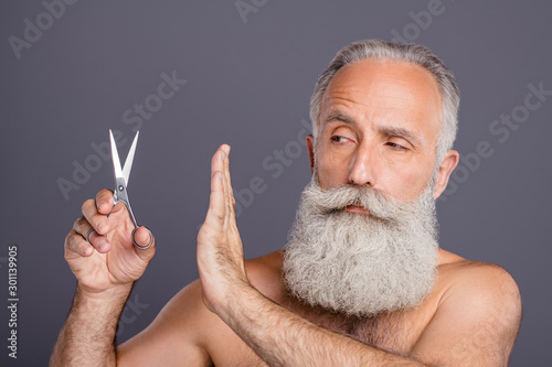 Billede på lærred Close up photo of serious candid man refusing to use scissors staring at them su