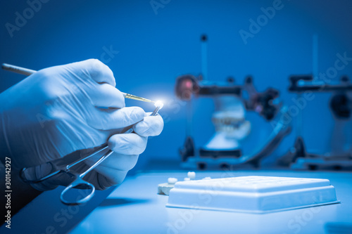 A dental technician makes a dental crown. laboratory. close-up