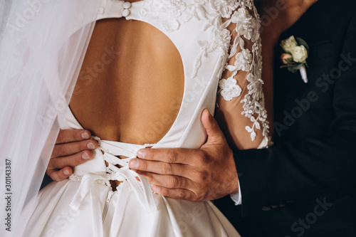 gentle touches of the bride and groom. selective focus, film and grain photo