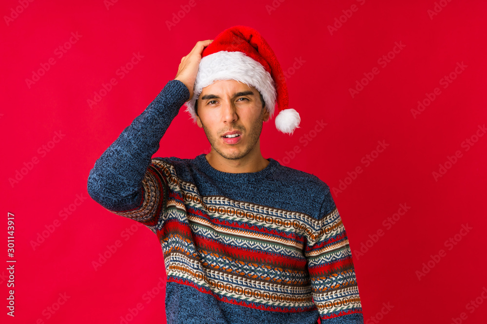 Young man on christmas day surprised and shocked.