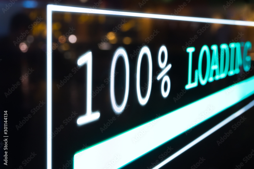 Close up and Selective focus. Futuristic transparent OLED screen dashboard illuminate blue pixel light and real-time display 100% loading status bar of computer network system information. Close up and Selective focus. Futuristic transparent OLED screen dashboard illuminate blue pixel light and real-time display 100% loading status bar of computer network system information.