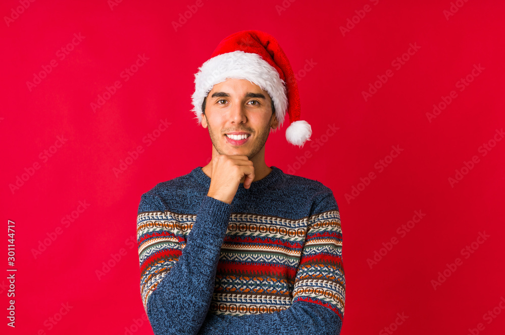 Young man on christmas day doubting between two options. Young man on christmas day doubting between two options.