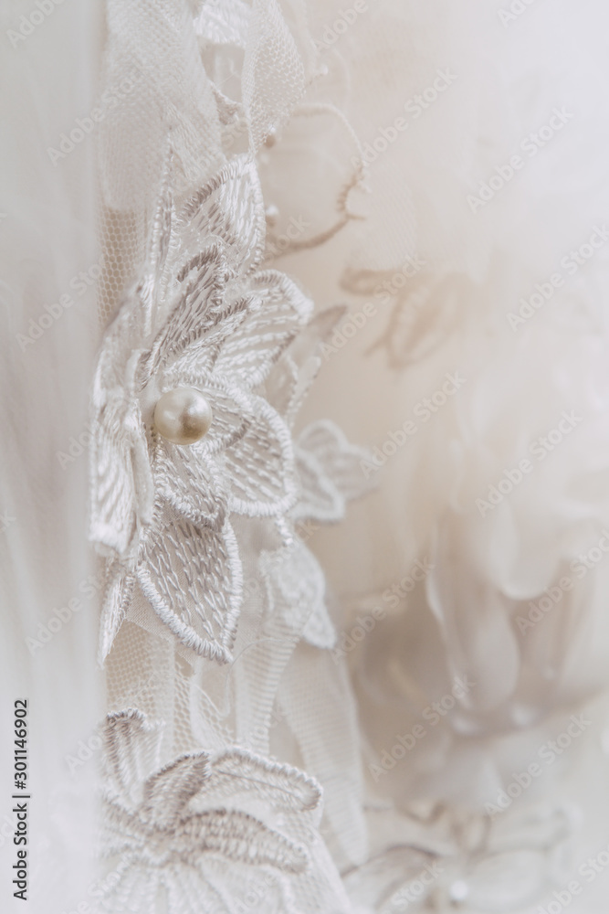 Details of the bride dress fabric and beautiful embroidery wedding concept used as a background for illustrations Details of the bride dress fabric and beautiful embroidery wedding concept used as a background for illustrations