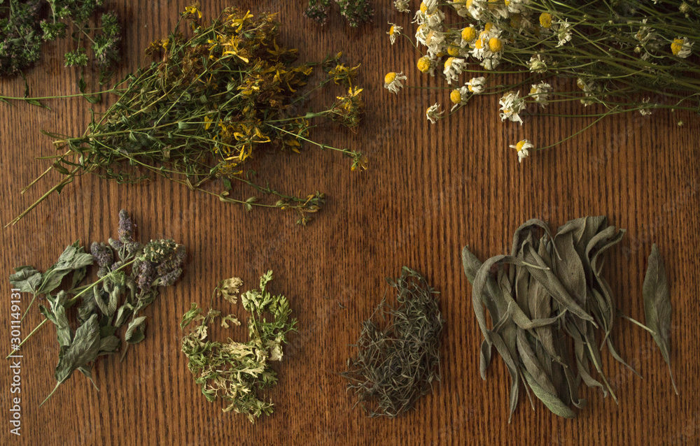 Dry herbs on wooden table