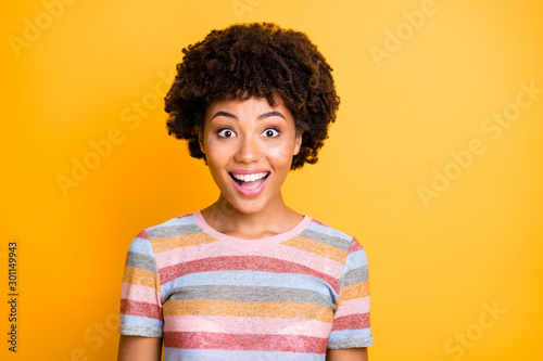Photo of ecstatic overjoyed brown haired black youngster hearing good news information smiling toothily isolated over yellow vivid color background © deagreez